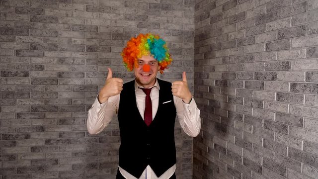 Office worker in clown wig, clown concept at work. Businessman with clown wig. Original clown costume for Halloween