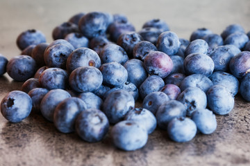 fresh raw blueberries on a gray kitchen desk