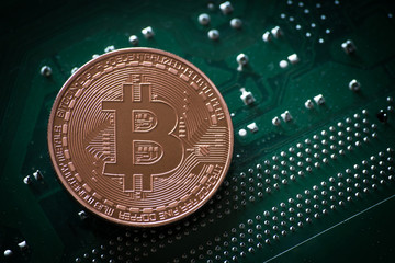 bitcoin symbol coin on computer part background