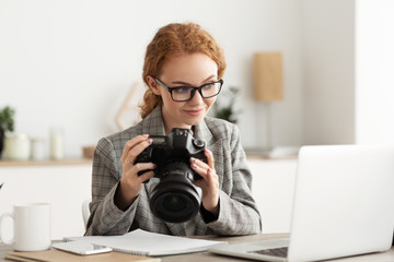 Journalist transfering image data on camera to laptop