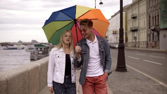 Young positive beautiful couple blond guy and a girl in stylish clothes