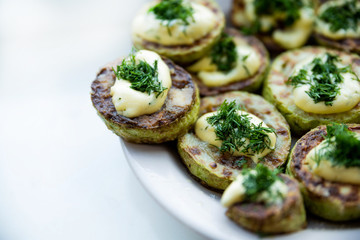 homemade zucchini fried with mayonnaise. On a white background