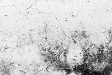 texture of an old wall with uneven cracked stucco, dirty surface of the exterior painted wall