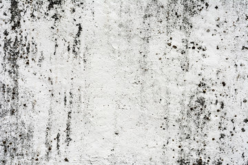 texture of an old wall with uneven cracked stucco, dirty surface of the exterior painted wall