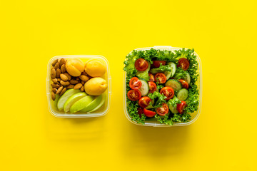 salad to go in lunch box on yellow background top view