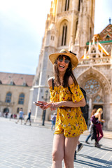 A young woman enjoying her trip to Budapest - obrazy, fototapety, plakaty