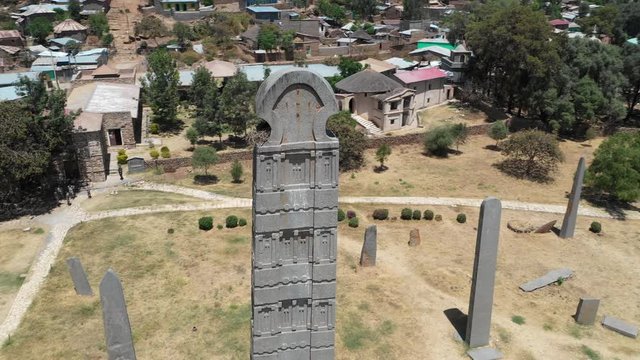 Ascending rotating drone shot flying around beautiful restored obelisk tower in former kingdom of Aksum, history and culture in Ethiopia Africa