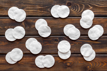 Hygiene cotton pads for pattern on wooden background top view