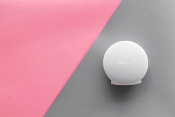 portable wireless speakers for music listening on pink and gray background top view mockup