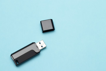 isolate flash drive on a blue background. electronics concept. memory for transferring files and information. small flash card.