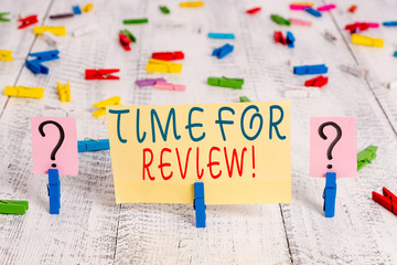 Writing note showing Time For Review. Business concept for formal assessment of something with intention instituting change Crumbling sheet with paper clips placed on the wooden table