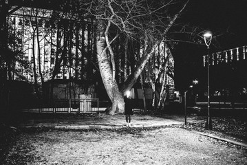 Film noir night scene woman hidden behind light