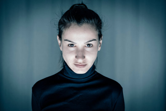 Portrait of young woman pawky smiling over blue background