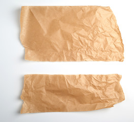 torn brown pieces of parchment paper on a white background