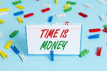 Text sign showing Time Is Money. Business photo showcasing time is a valuable resource Do things as quickly as possible Colored clothespin papers empty reminder blue floor background office pin