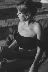 Amazing sensual seductive woman siting on deckchair, enjoying summer holidays near the pool. Wearing trendy swimsuit