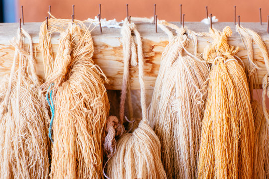 Woolen yarn arranged on wooden rack