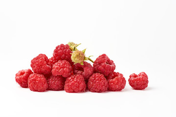 bunch of red ripe raspberries on a white background