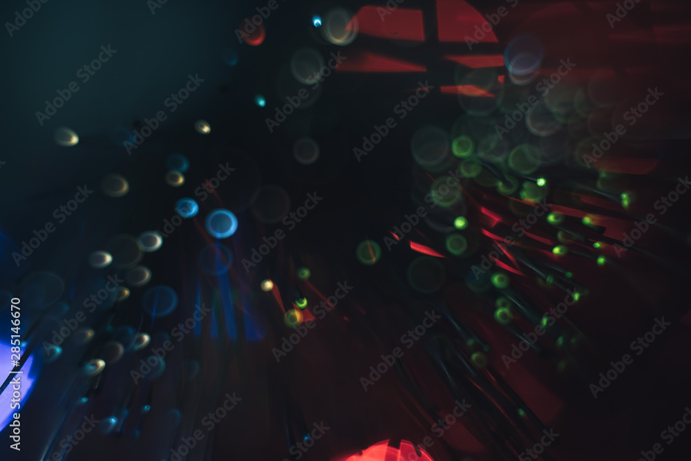 Aufkleber beautiful multi-colored abstract optical fiber line on a red bokeh background.
