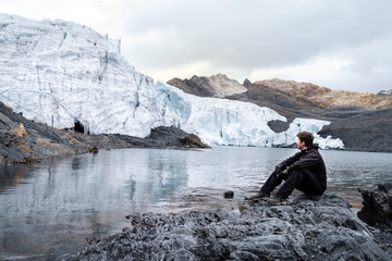 Tourist man looking at the Pastoruri Glacier in one of the highest points of Cordillera Blanca in...