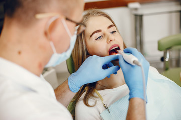 Beautiful lady in the dentist's office. Woman in a uniform