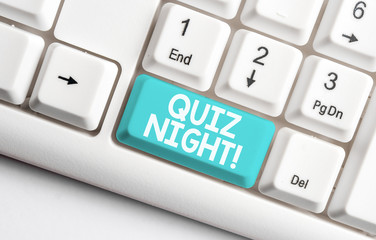 Conceptual hand writing showing Quiz Night. Concept meaning evening test knowledge competition between individuals White pc keyboard with note paper above the white background
