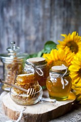 Honey and Herbal tea on wooden background - summer, health and organic food concept