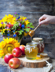 Honey and Herbal tea on wooden background - summer, health and organic food concept