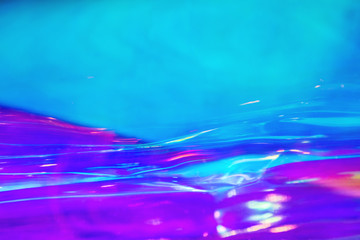 Abstract trendy holographic background in 80s style. Blurred texture in violet, pink and mint...