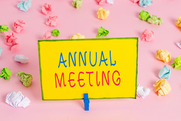 Word writing text Annual Meeting. Business photo showcasing yearly meeting of the general membership of an organization Colored crumpled papers empty reminder pink floor background clothespin