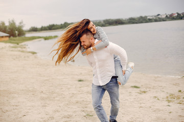 Couple in a park. Woman with long curly hair. Man with his wife