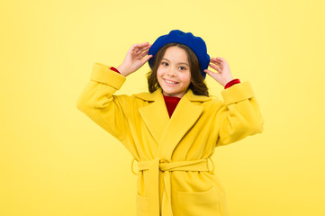 Autumn joy. happy childhood. small child with curly hair. cheerful little girl in yellow coat. parisian girl kid in french beret. autumn fashion style. fall season. beauty and fashion. autumn coat