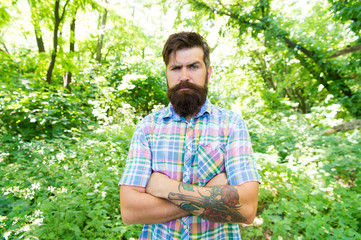 Eco lifestyle. United with environment. Handsome lumberjack. Man bearded hipster green trees background. Guy relax in summer nature. Man beard and mustache in summer forest. Summer vacation concept