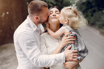 Fototapeta premium Family in a summer park. Mother and little daughter playing. Cute little girl with a father