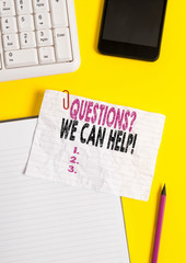 Text sign showing Questionsquestion We Can Help. Business photo text offering help to those who wants to know Crumpled white paper on table with paper clips clock mobile and pc keyboard