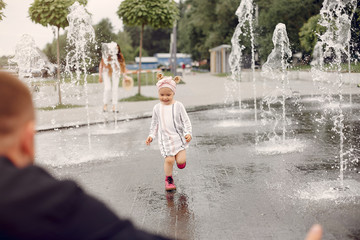 Family in a summer park. Mother and little daughter playing. Cute little girl with a father