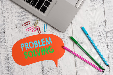 Handwriting text Problem Solving. Conceptual photo process of finding solutions to difficult or complex issues Trendy metallic laptop speech bubble colored clips pens lying vintage table