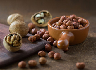Filbert and walnuts on a rusty metal surface. 