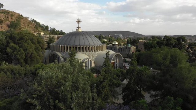 Drone flight over trees reveals beautiful rebuilt Church of Our Lady Mary of Zion in Aksum, one of Ethiopia's most sacred and holiest sites