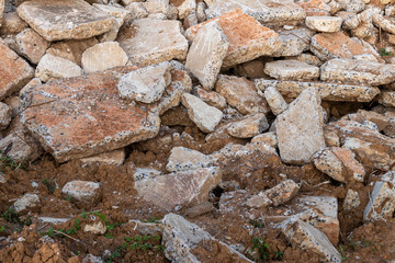 Background of concrete debris piles on the ground.