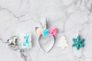 Set of various white, pink and blue Christmas decorations: gifts and toys on marble background. Top view, flat lay.