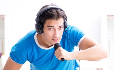 Young man singing at home karaoke