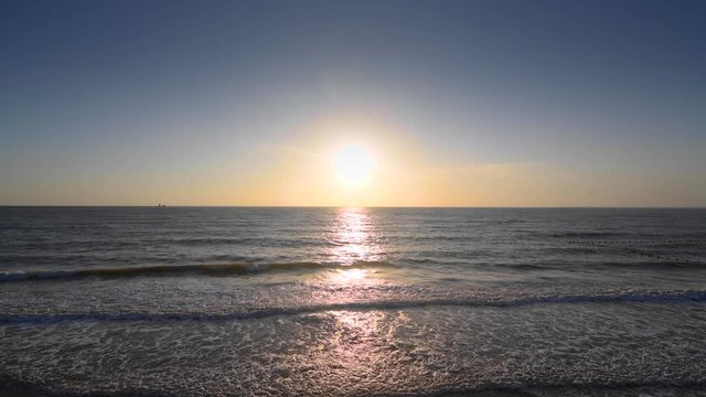 The ocean under the blue sky and the sunset in the evening 