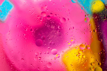 Micro molecular abstract pattern of colored oil bubbles on water. 