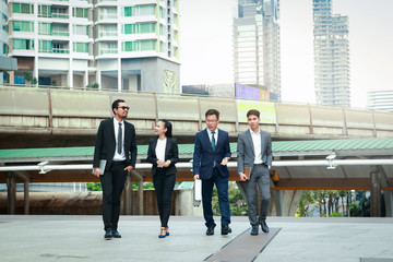 Four Asian businessmen discuss work and financial investments.