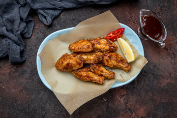 chicken wings in barbecue sauce on dark concrete rustic table