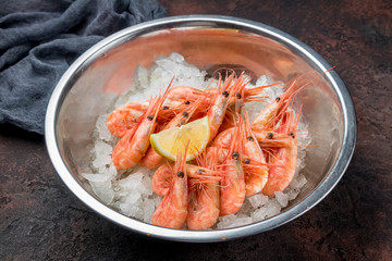 boiled shrimp on ice on dark concrete rustic table