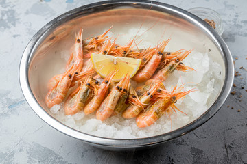 boiled shrimp on ice with smoke on grey concrete table
