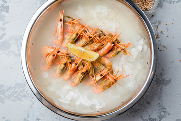 boiled shrimp on ice with smoke on grey concrete table