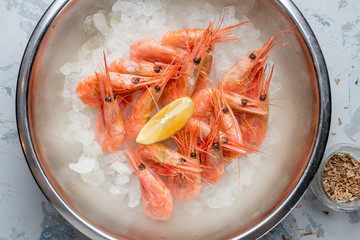 boiled shrimp on ice with smoke on grey concrete table